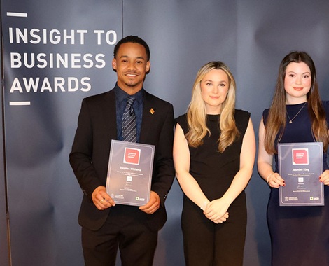 students standing with employer holding certificates